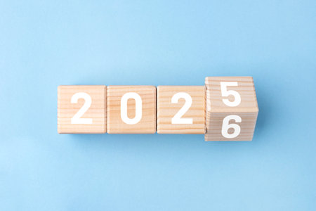 Wooden cubes with alternating numbers of 2026 on the blue backgroundの写真素材