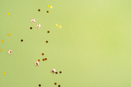 Gold confetti on green background. Flat lay, top viewの写真素材