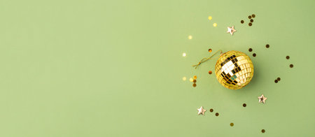 Festive Christmas gold ball on a green background.の写真素材