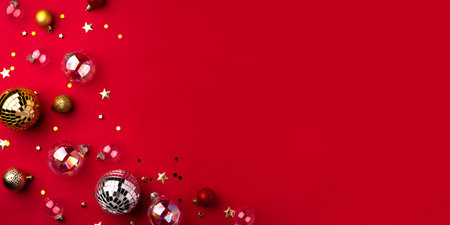 Festive Christmas ornaments on a red background.