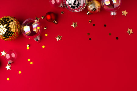 Festive Christmas ornaments on a red background.