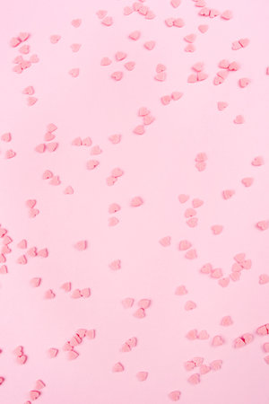 Pink background with tiny hearts. Valentine's day concept. Top view.