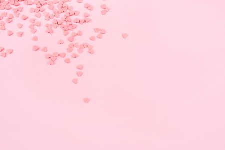 Pink background with tiny hearts. Valentine's day concept. Top view.