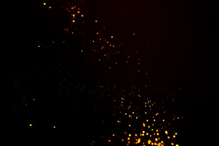 Golden abstract bokeh on black background. Holiday concept