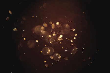 Golden abstract bokeh on black background.の写真素材
