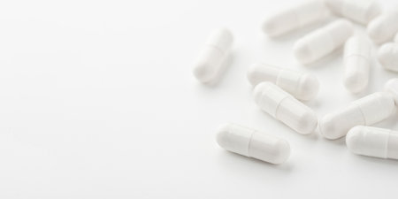 White pills on a white background. Close up