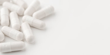 White pills on a white background. Close upの写真素材
