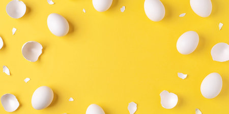 Minimalistic Easter background. White Easter eggs and shells on a bright yellow background. Card...