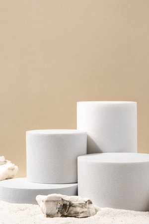 Natural cosmetic background for product presentation. White podiums on the sand. Front view.の写真素材