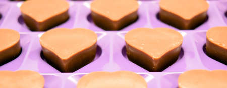 heart shaped dark chocolate in purple box frameの写真素材