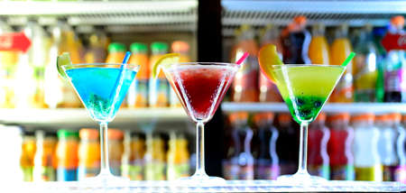 3 cocktails displayed on the counter in a bar
