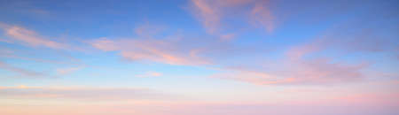 Clear blue sky with glowing pink cirrus and cumulus clouds after storm at sunset. Dramatic cloudscape. Concept art, meteorology, heaven, hope, peace, graphic resources, picturesque panoramic sceneryの写真素材
