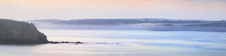 Anse de Camaret Celtic sea bay at sunrise. Cliffs in a clouds of fog. Panoramic aerial view. Idyllic landscape. Travel destinations, nature, environment, tourism, landmarksの写真素材