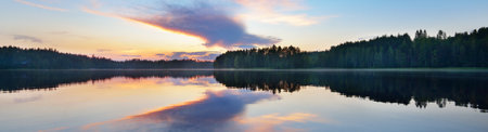 Blue Saimaa lake, evergreen forest, Finland. Picturesque panoramic scenery. Reflections in the water. Atmospheric landscape. Pure nature, ecology, environmental conservation, travel destinationsの写真素材