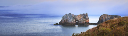 Anse de Camaret Celtic sea bay at sunrise. Cliffs in a clouds of fog. Panoramic aerial view. Idyllic landscape. Travel destinations, nature, environment, tourism, landmarksの写真素材