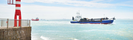 Cargo ships sailing near Vlissingen, the Netherlands. Panoramic view. Freight transportation, fuel,...
