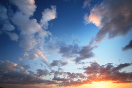Clear blue sunset sky with colorful cumulus clouds. Abstract natural pattern, texture, close-up. Concept art, meteorology, ecology, climate change, religion, heaven, graphic resourcesの写真素材