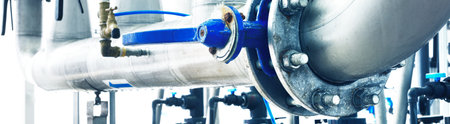Large industrial water treatment and boiler room. Shiny steel metal pipes, blue pumps, valves. Industry, technology, special equipment, biotechnology, chemistry, ecology, environmental damage, heatingの写真素材