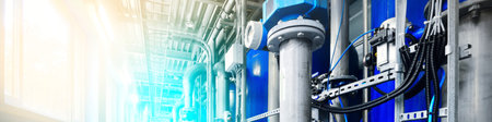 Large industrial water treatment and boiler room. Shiny steel metal pipes, blue pumps and valves. Industry, technology, special equipment, chemistry, environment, heating, work safety. Panoramic viewの写真素材