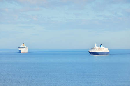 Passenger ship (cruise liner) sailing in an open sea on a clear day. Panoramic aerial view. Mediterranean sea, Spain. Travel destinations, summer vacations, recreation conceptsの写真素材