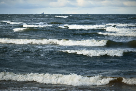 Storm clouds above the Baltic sea, cyclone in winter. Dramatic sky, waves and water splashes....