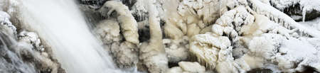Close-up of the frozen waterfall with icicles. Abstract natural pattern, texture, background....