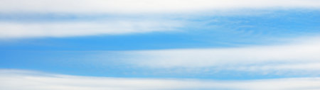 Clear blue sky with glowing white cirrus and cumulus clouds. Panoramic dramatic cloudscape. Concept art, meteorology, climate change, religion, heaven, hope, peace. Graphic resources, copy spaceの写真素材