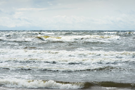 Baltic sea under dramatic sunset clouds after thunderstorm. Waves close-up. Latvia. Epic seascape....