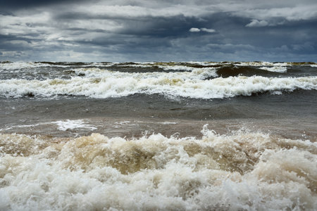 Baltic sea under the dark dramatic clouds after thunderstorm. Latvia. Epic seascape. Cyclone, gale, storm, rough weather, meteorology, ecology, climate change, natural phenomenonの写真素材