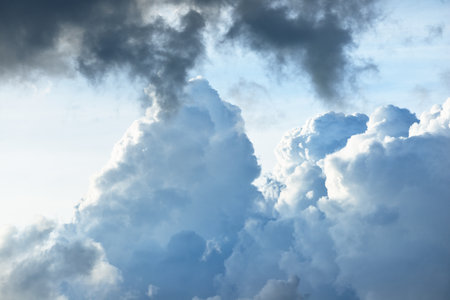 Clear blue sky with cumulus clouds. Dramatic cloudscape. Abstract natural pattern, texture, close-up. Concept art, meteorology, ecology, climate change, religion, heaven, graphic resourcesの写真素材