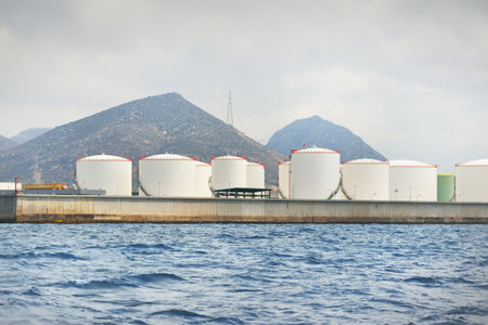 Oil terminal and cargo port, close-up view from the sailing boat. Mediterranean sea, Cartagena,...