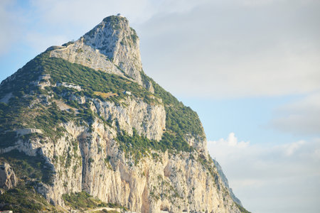Rocky shores (cliffs, mountains) of the Europa Point, a view from the sailing boat. Gibraltar, British Overseas Territory. Travel destinations, national landmark, sightseeing themeの写真素材