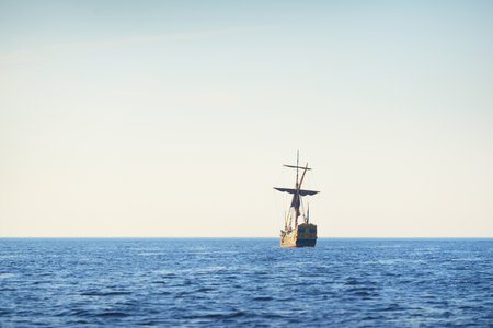 18th century sailing yacht in an open sea at sunset, close-up. Holland. Old tall ship. Recreation, vacations, cruise, historical reenactment, past, historyの写真素材