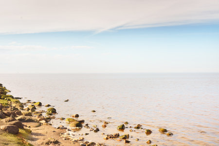 Panoramic view from the rocky sea shore on a clear sunny day. Blue sky, cirrus clouds. Idyllic...