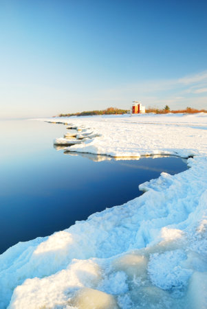 Meteorological station on the frozen sea shore on a clear day. Concept winter scene. Meteorology, science, ecological issues, environmental conservation, global warming, climate changeの写真素材