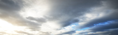 Clear blue sky with glowing cumulus clouds after a blizzard at sunset. Dramatic winter cloudscape....