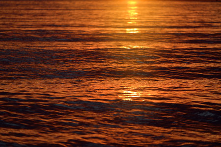 Baltic sea at sunset. Dramatic sky and golden sunlight reflecting in the water. Abstract natural...