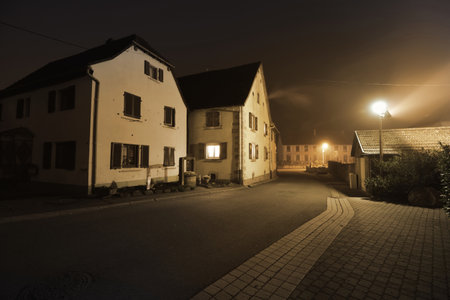 Panoramic view (cityscape) of the illuminated empty street in Alsace, France. Atmospheric urban scene. Exterior of traditional houses. Landmarks, sightseeing, travel guide, architecture, cultureの写真素材