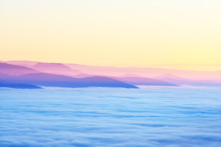 Evening fog. Beautiful aerial view of the mountains and valleys at sunset. French Alsace, Vosges...
