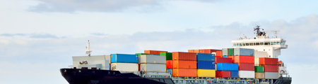 Large cargo container ship sailing in a still sea water on a clear day. Panoramic view. Freight transportation, global communications, logistics, industry, business, economy, environmental damageの写真素材
