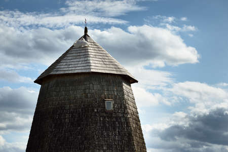 An old traditional mill close-up. Cloudy blue sky. Latviaの写真素材