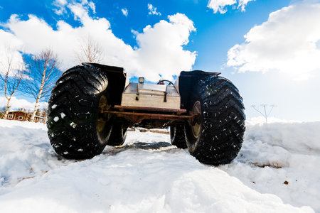 A hand made all terrain vehicle on the snow-covered field, close-up. Winter country landscape. Karelia North, Lapland, Kuito lakeの写真素材