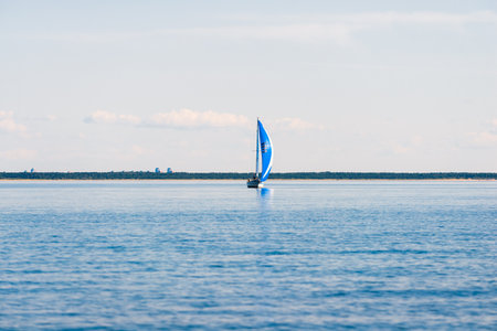 Sailing yacht regatta. Modern sailboat racing with blue spinnaker sails. Clear summer day. Kiel, Germanyの写真素材