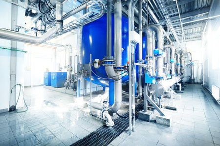 Large industrial water treatment and boiler room. Shiny steel metal pipes, pumps, valves. Industry, technology, special equipment, biotechnology, chemistry, ecology, heating, workplace safetyの写真素材