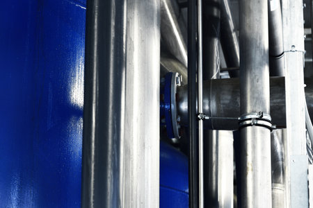 Large industrial water treatment and boiler room. Shiny steel metal pipes, pumps, valves. Industry, technology, special equipment, biotechnology, chemistry, ecology, heating, workplace safetyの写真素材