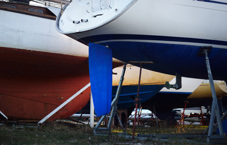 Yachts standing in stands ashore in the yachtclub. Winter sunset. Riga, Latviaの写真素材