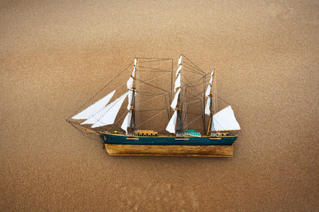Antiquarian wooden scale model of the clipper tall ship isolated on natural background, close-up....