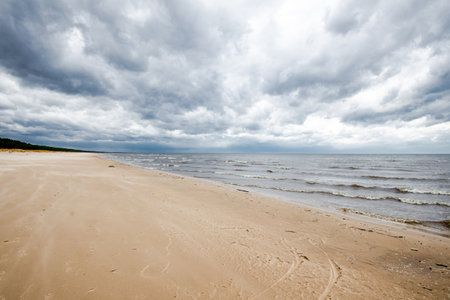 Spring landscape. Dark stormy sky over the Baltic sea, Latviaの写真素材