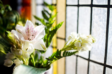 Wedding bouquet in front of the stained glass window. Alstroemeria close-up. Riga, Latviaの写真素材