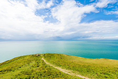 Aerial view from the cliffs of the English Channel. Green grass, azure water, clear blue sky....
